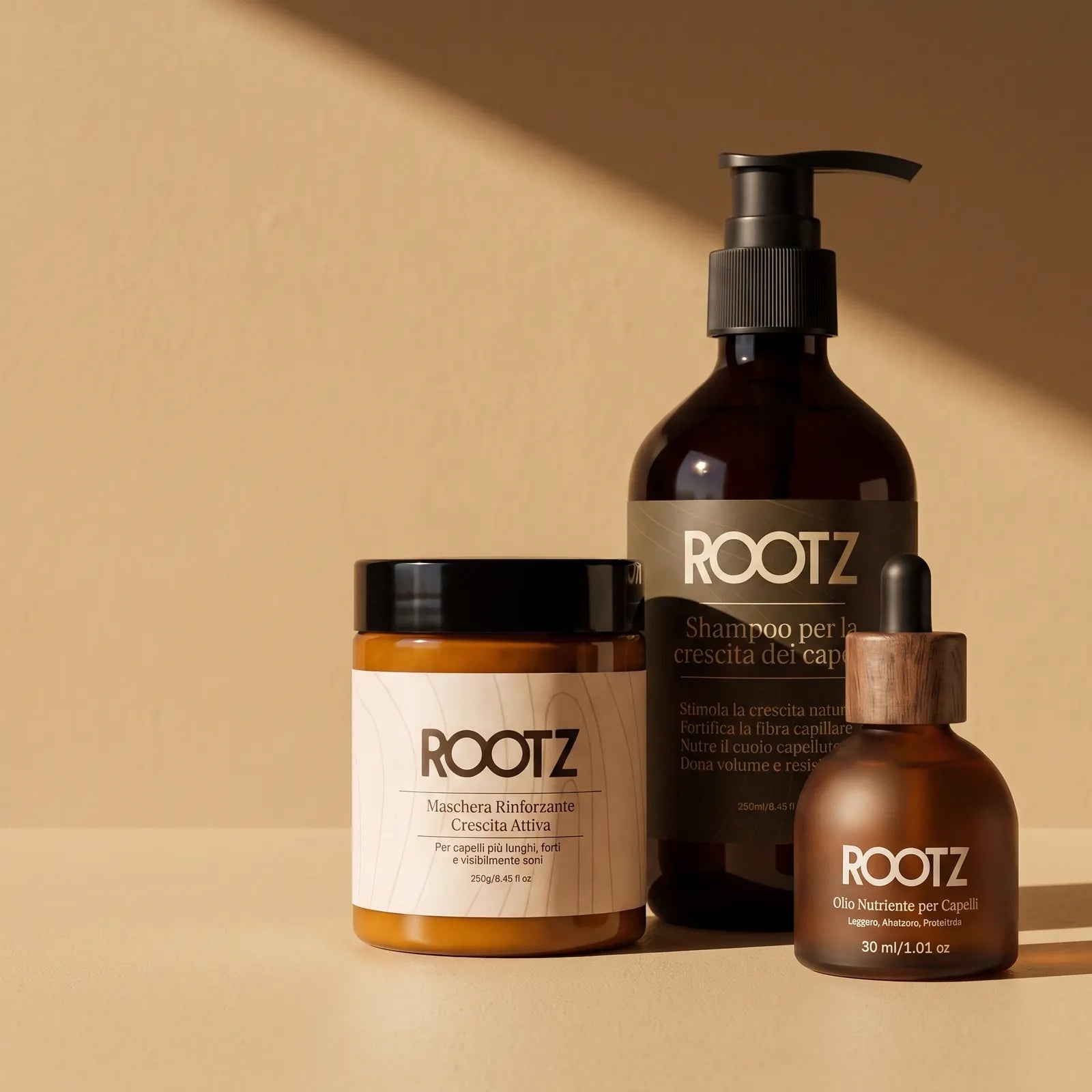 Champú, mascarilla y aceite ROOTZ uno al lado del otro sobre un fondo claro